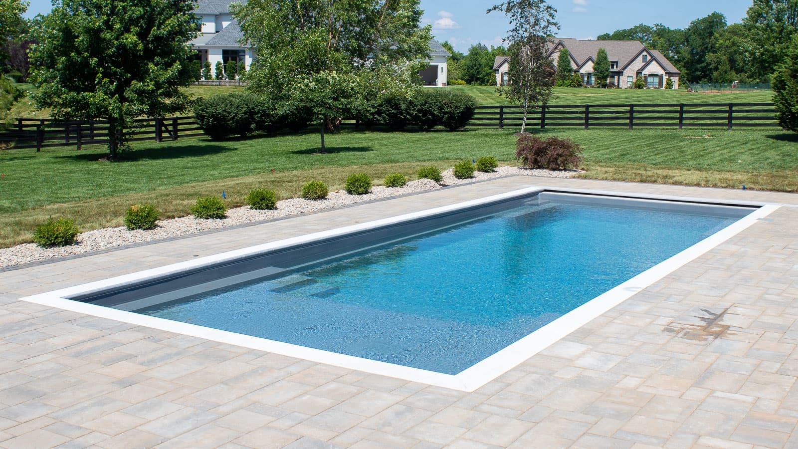 Rectangular fiberglass inground pool with premium backyard design